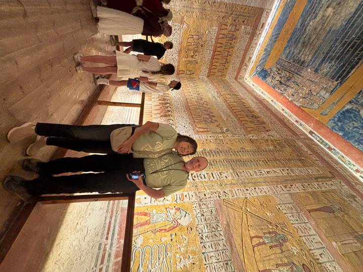 Couple poses inside a vividly painted pharaonic tomb in the Valley of the Kings.