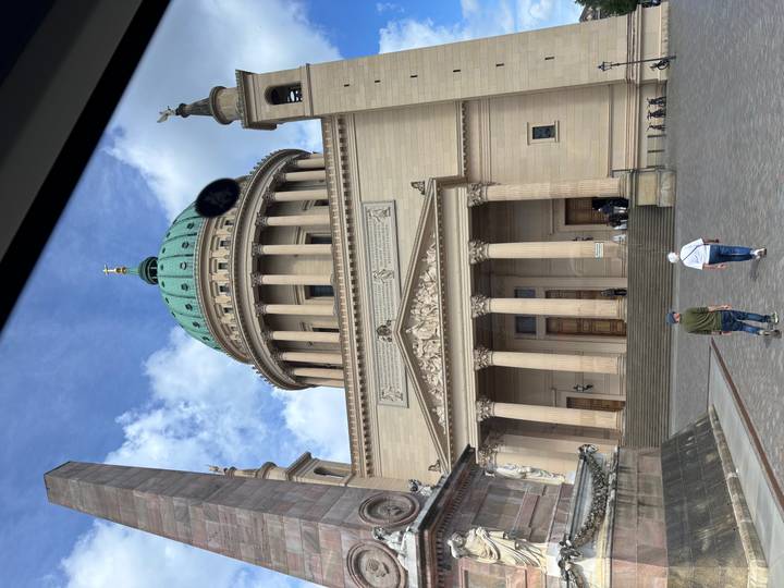 Large neoclassical domed church viewed from street level; smudge visible on lens.