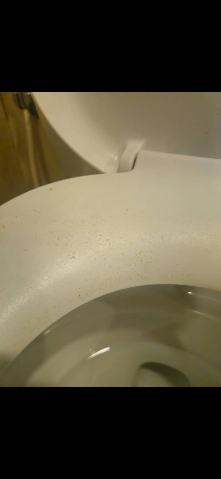 Soft-focus image of a lightly stained surface edge, offering little context.