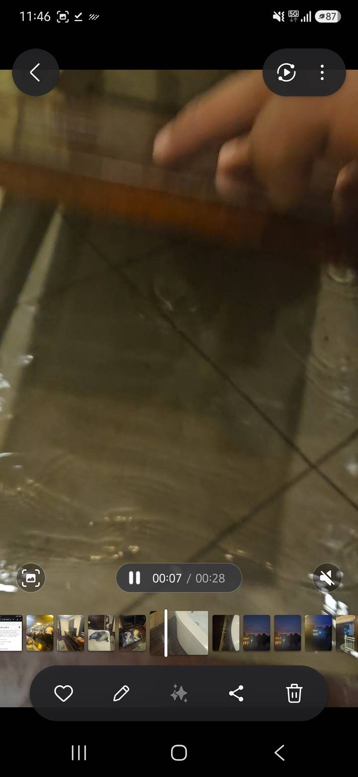 Very blurry image of a wet dark surface with indistinct reflections.
