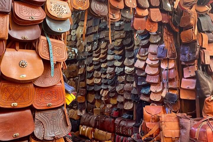 Colorful display of handmade leather bags hanging in Marrakesh souk