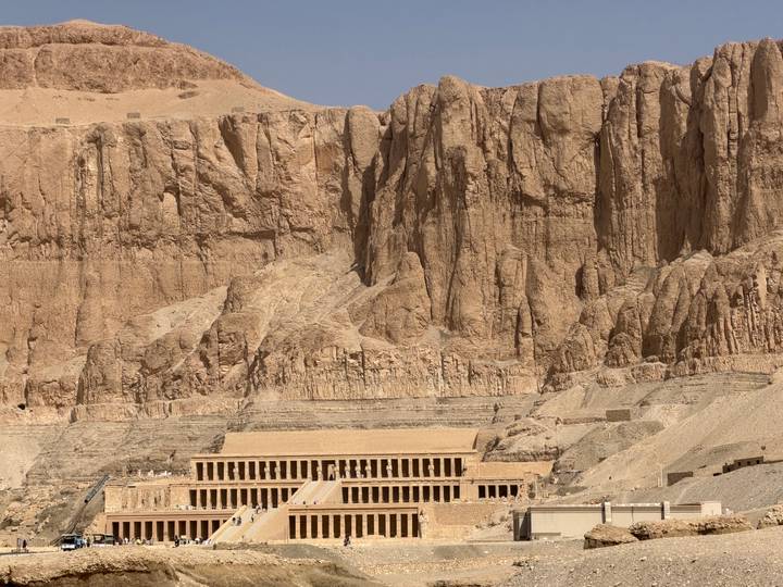 Mortuary temple of Hatshepsut nestled against towering desert cliffs in Luxor