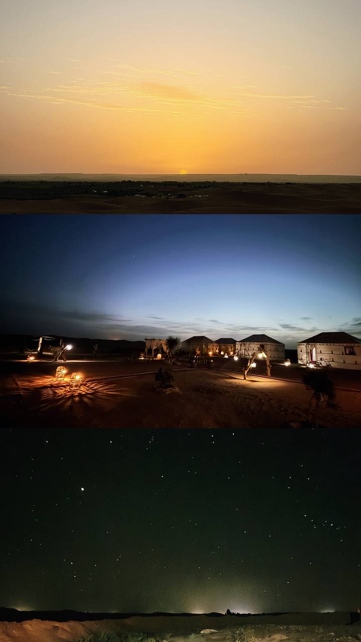 Remote desert camp at twilight with canvas tents softly lit by lanterns.