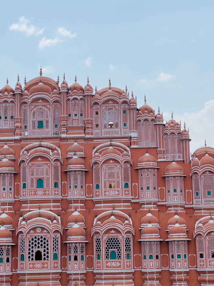 The pink sandstone honeycomb facade of Jaipur's Hawa Mahal fills the frame
