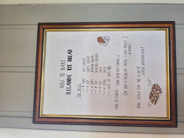 Framed poster displaying a handwritten recipe for traditional Icelandic rye bread hanging on a wooden wall.