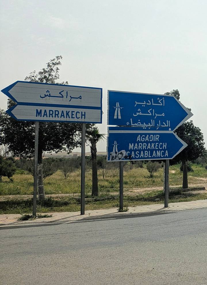 Highway directional signs pointing to Agadir, Marrakech and Casablanca in Arabic and French