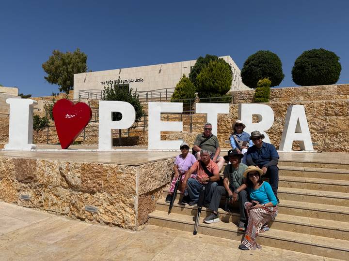 Group photo in front of the large 'I ♥ PETRA' sign near the Petra visitor complex.