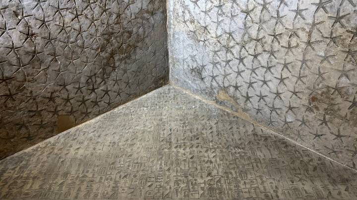 Interior pyramid walls covered with star and hieroglyph patterns at Saqqara.