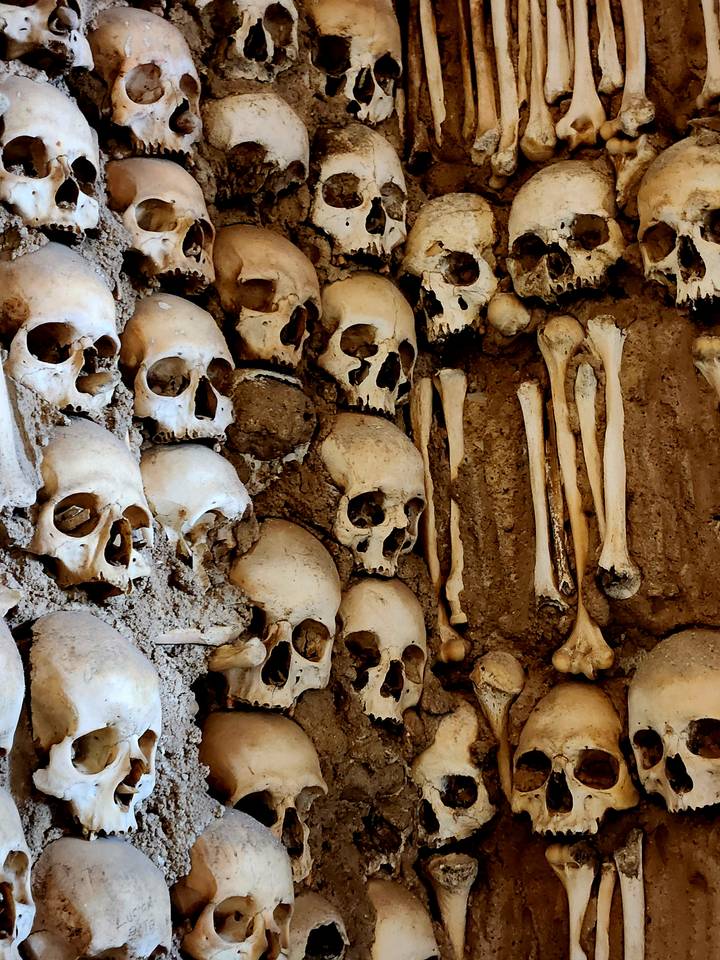 Wall of human skulls and bones forming the ossuary decor in a chapel