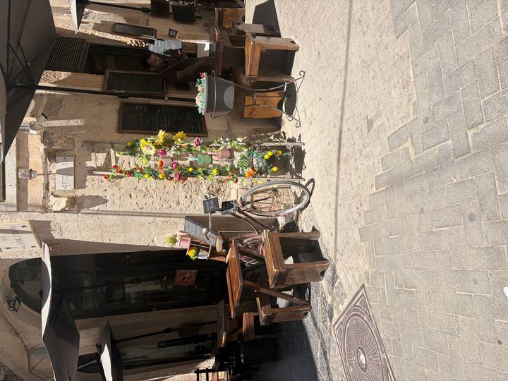 Quaint Sicilian café exterior decorated with lemons and a vintage bicycle