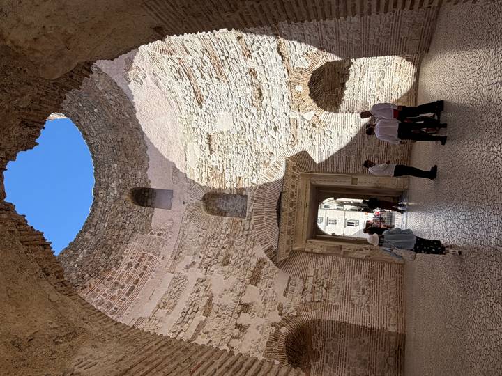 Interior of Diocletian’s Palace with soaring circular walls open to blue sky