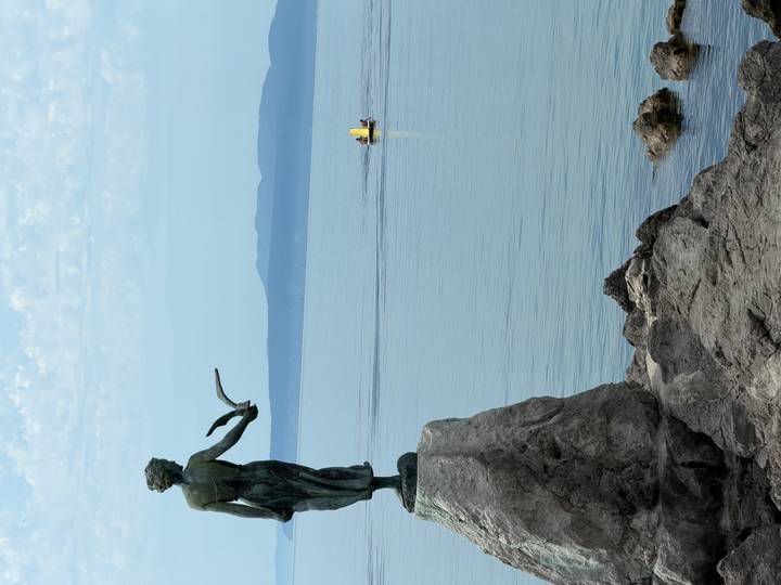 Maiden with the Seagull statue overlooking calm Adriatic waters