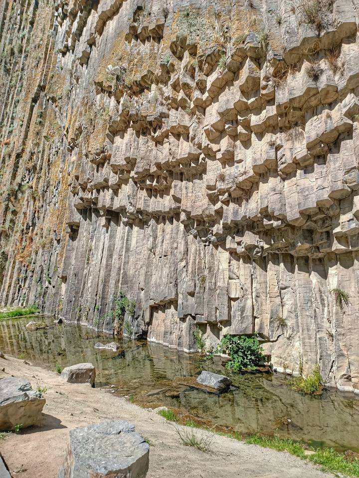 Basalt organ-pipe rock formations forming vertical columns in a canyon