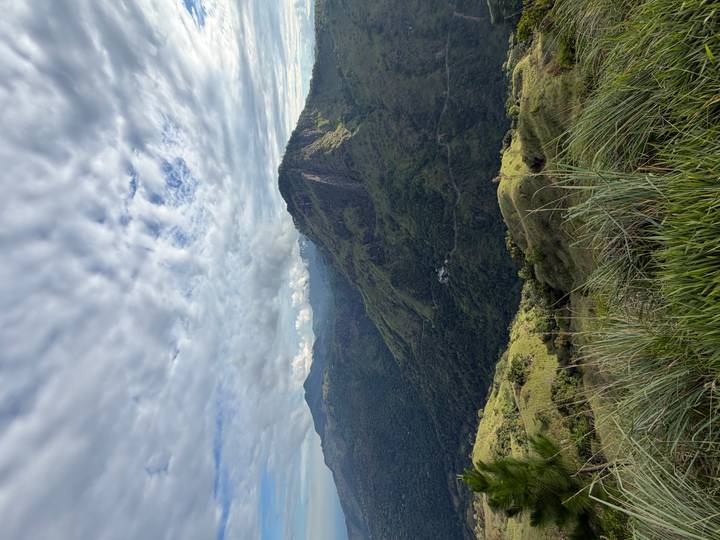 Sweeping mountain vista near Ella with dramatic ridges under a sky filled with textured clouds.