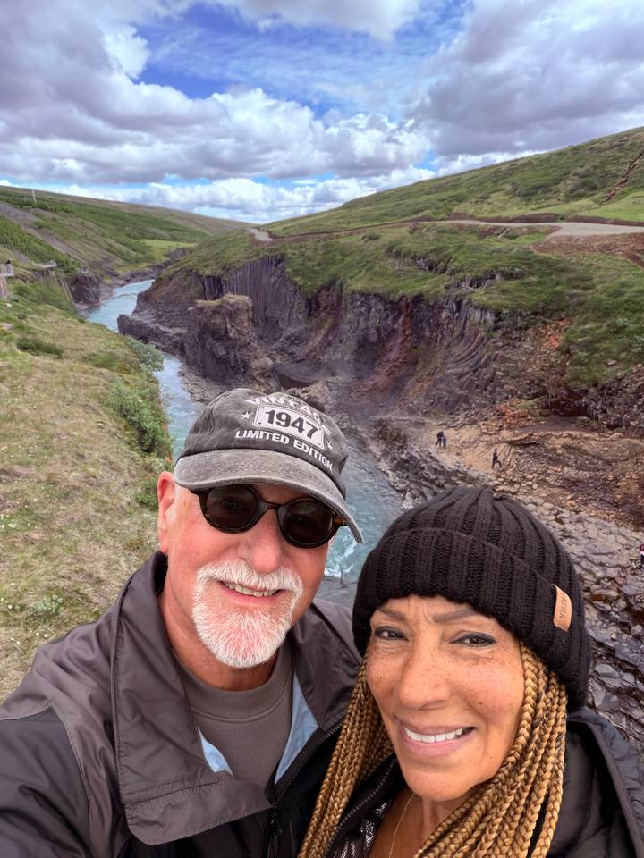 Selfie with rugged canyon walls and a turquoise river snaking through below