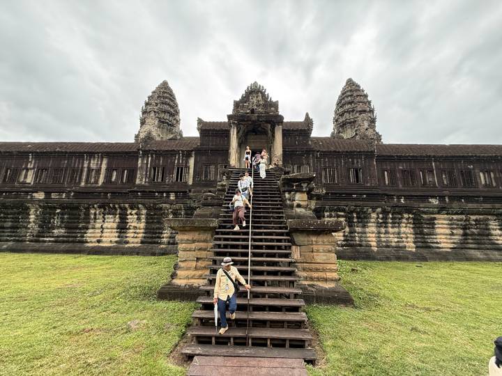 Tourists descending the central staircase of Angkor Wat main building