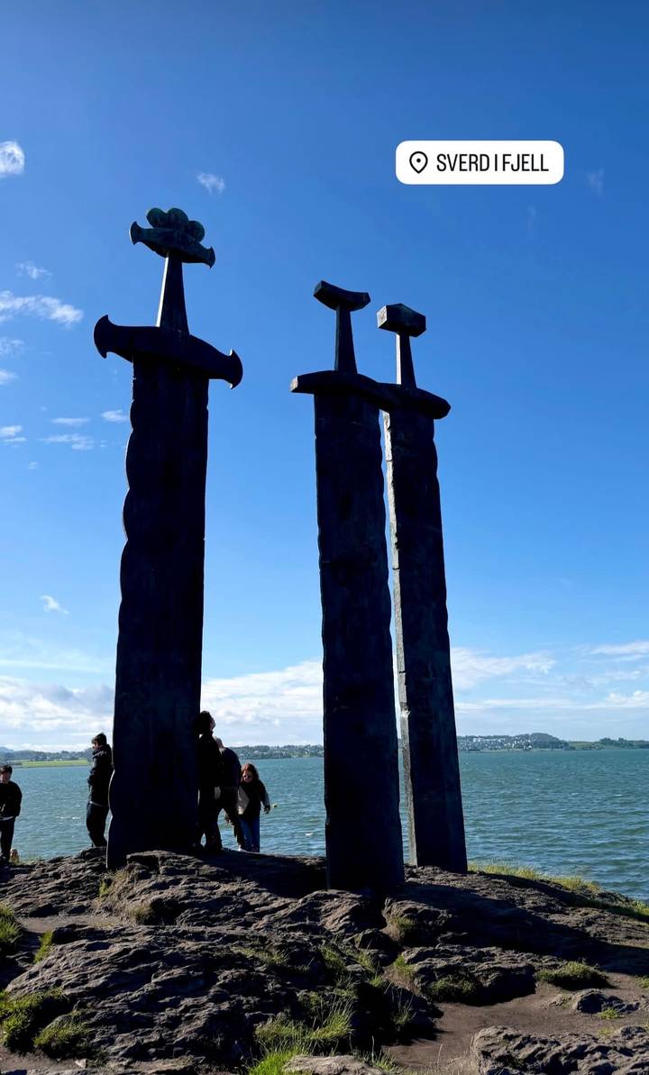 Silhouette of the three giant Viking swords monument set against a clear blue sky.