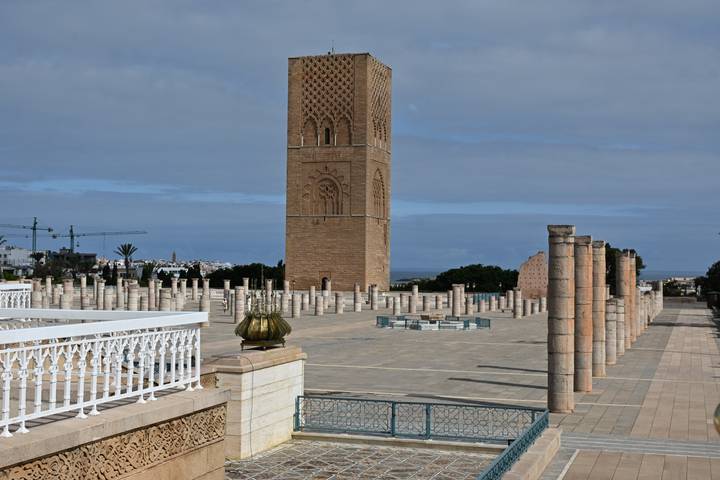 The Hassan Tower and surrounding marble columns under a partly cloudy sky in Rabat.