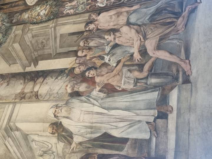 Large monochrome fresco depicting robed figures and animals inside an Italian basilica.