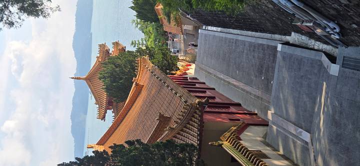 Descending pathway between temple rooftops overlooking Sun Moon Lake waters