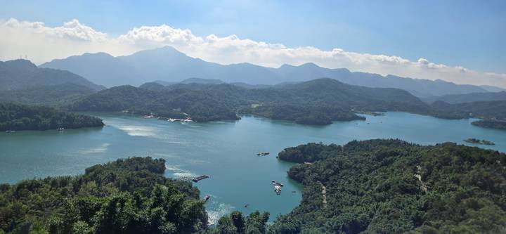 Panoramic aerial view of Sun Moon Lake surrounded by forested hills and mountains