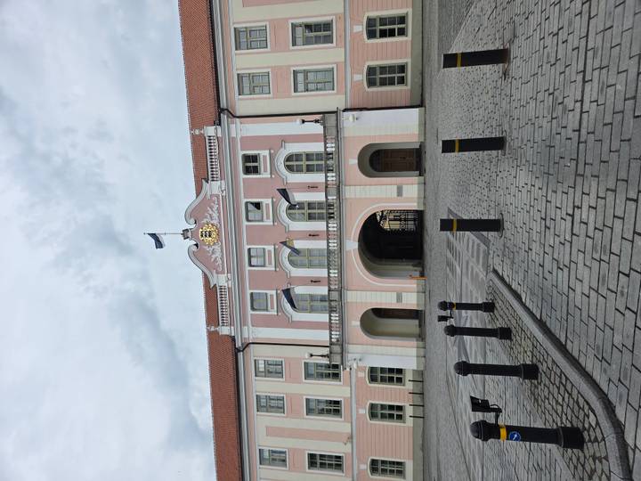 Pink-fronted Toompea Castle, seat of Estonia's parliament, faces an empty cobbled courtyard.