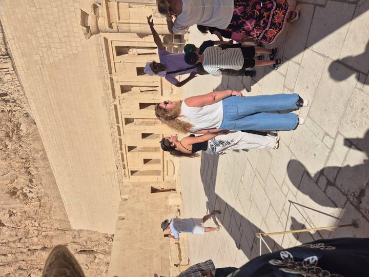 Tour group listens to a guide outside the massive stone terrace of Queen Hatshepsut’s temple in Luxor.