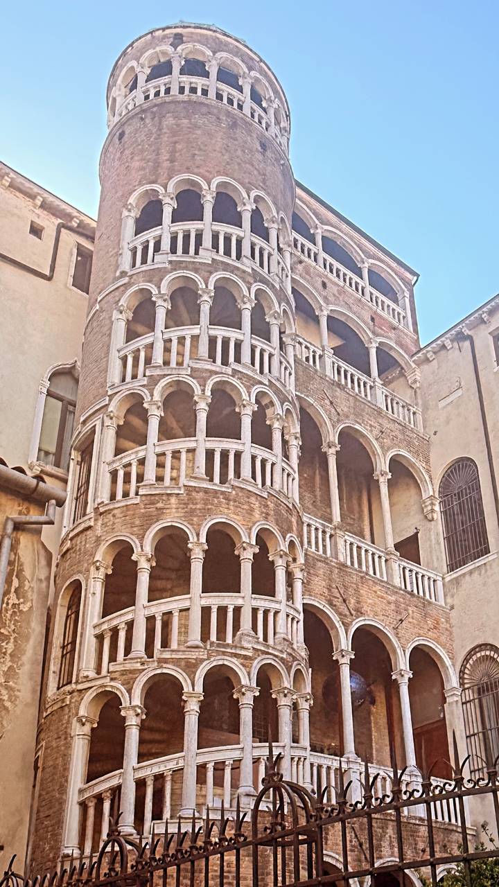 Historic brick palace in Venice featuring the spiral arches of Scala Contarini del Bovolo.