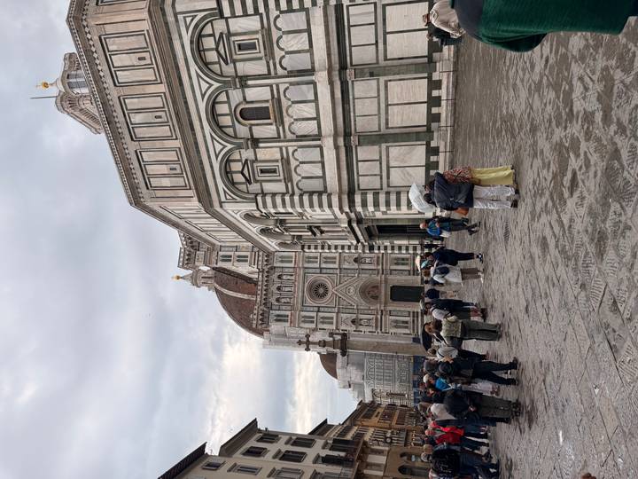 Crowds gather in front of Florence’s cathedral and the Baptistery with its distinctive marble façade.