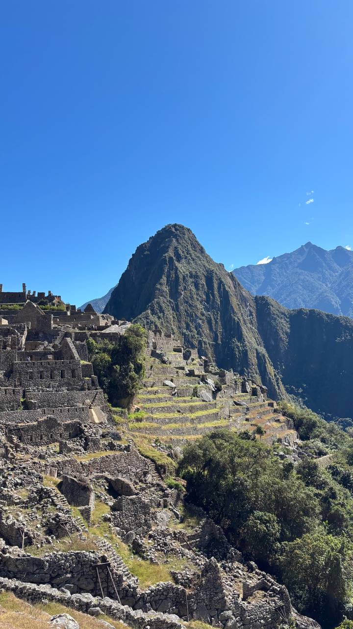 Classic view of Machu Picchu ruins with Huayna Picchu mountain dominating the scene.