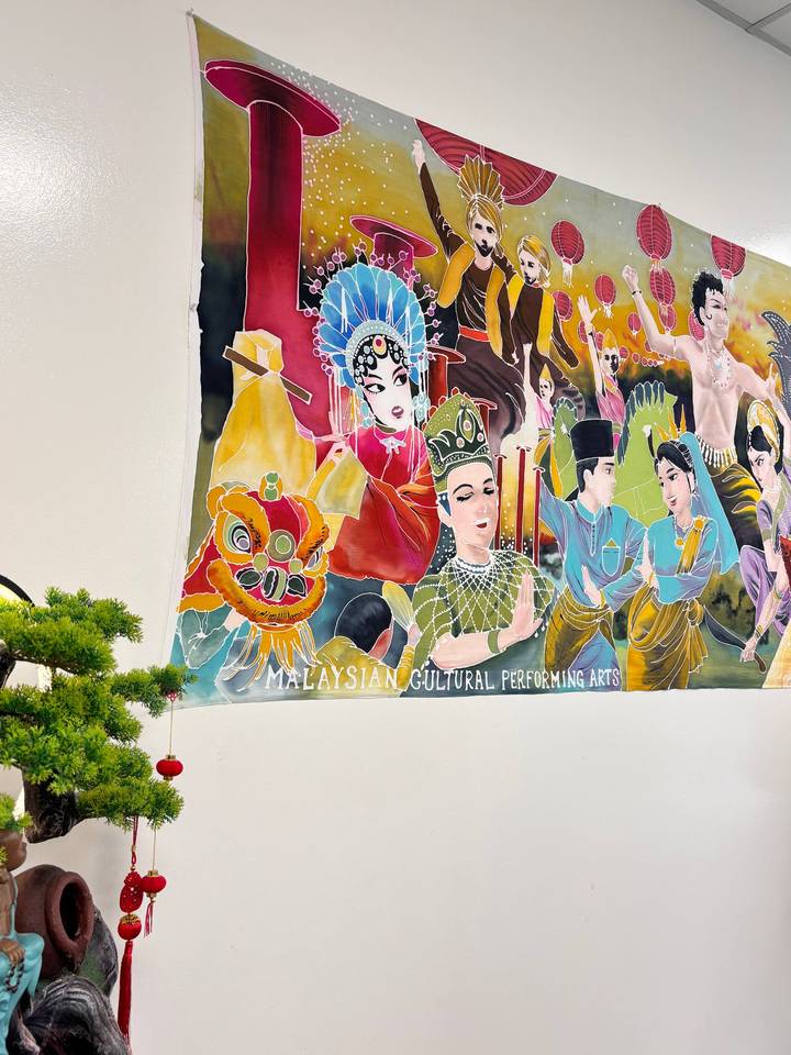 Colourful wall mural celebrating Malaysian performing arts inside a cultural centre