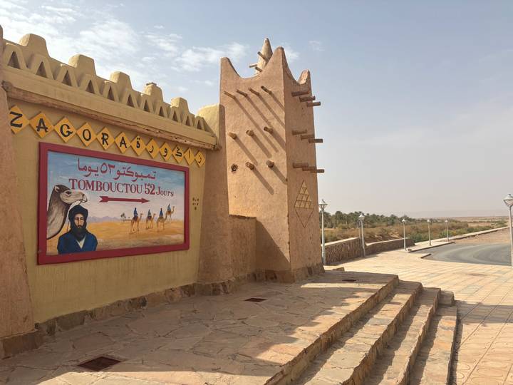 Adobe gateway featuring the famous Zagora sign indicating 52 days to Timbuktu.