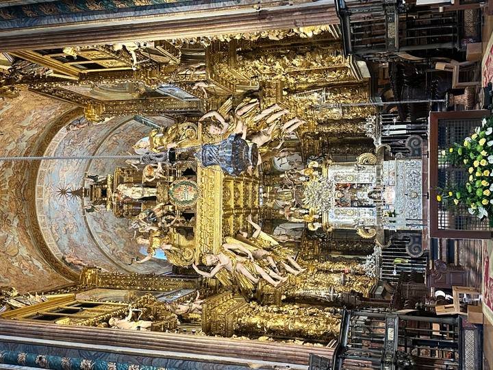 Opulent gilded baroque altar and nave inside Santiago de Compostela Cathedral.