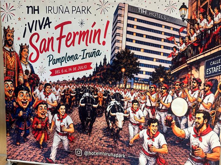 Colorful poster celebrating Pamplona's San Fermín festival with cartoon bulls and runners.