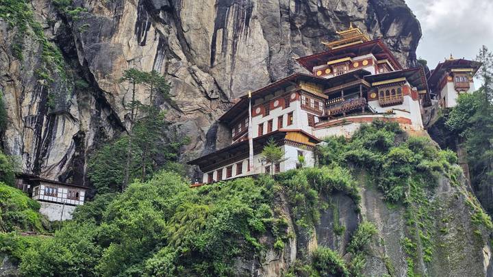 Close-up view of Tiger's Nest Monastery blending into the rugged cliff face and greenery