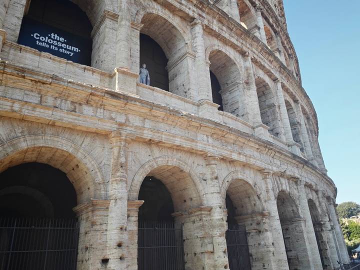 Close-angle architectural detail of the Colosseum’s arches and travertine stone in sunlight