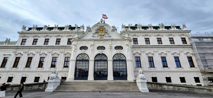 Grand baroque façade of Vienna’s Upper Belvedere Palace crowned by an Austrian flag.