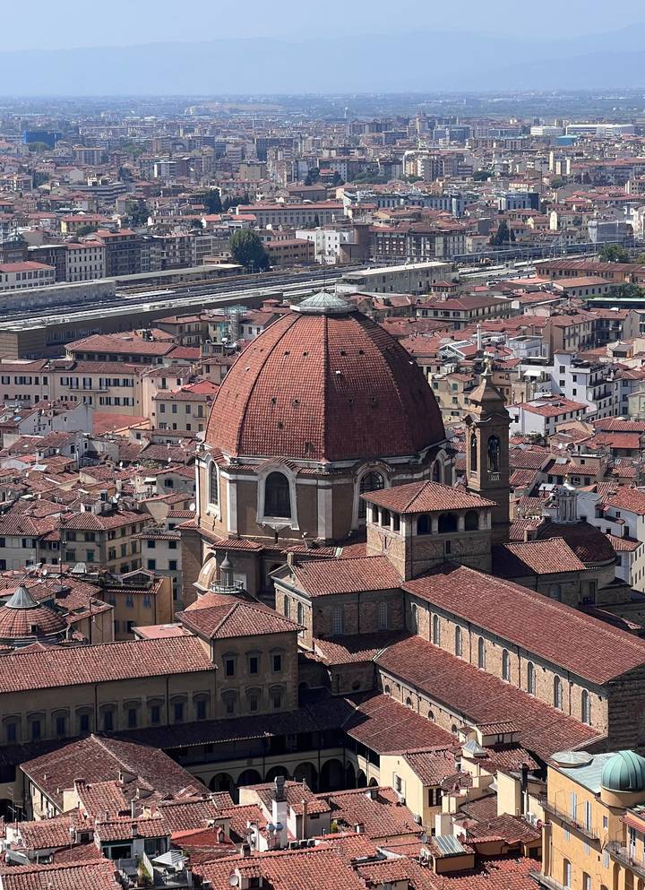 High vantage view of red-tiled dome rising above clustered Florence rooftops