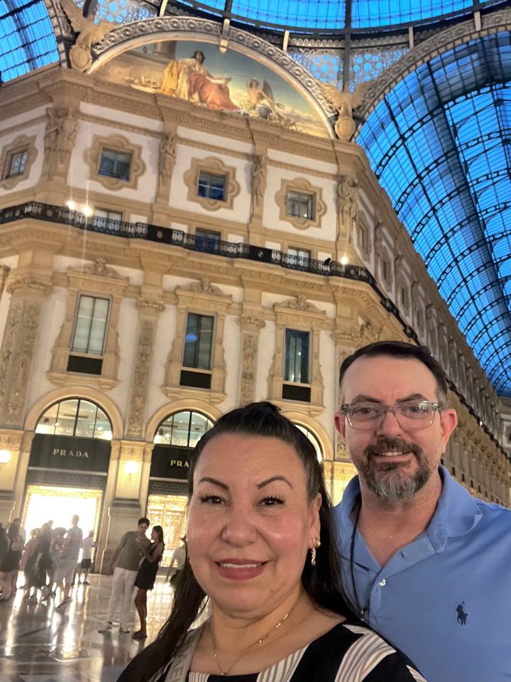 Partial selfie of couple inside luxury arcade, camera cutting off lower faces