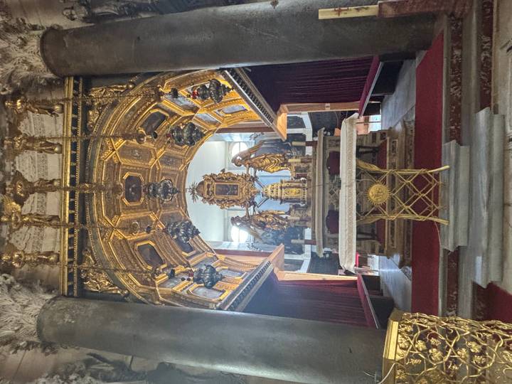 Ornate gold altar and statues inside a richly decorated Venetian chapel.