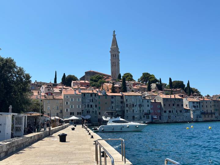 Seaside view of Rovinj’s pastel old town and tall campanile rising above the Adriatic.