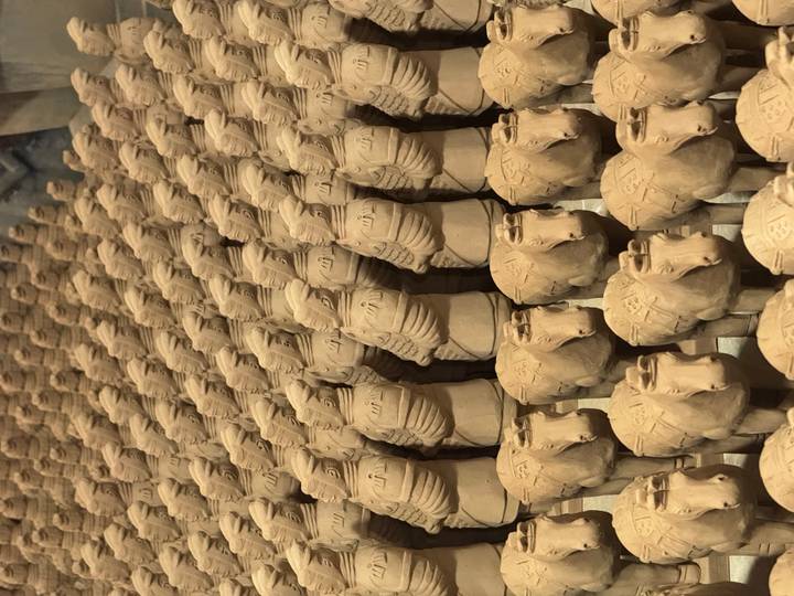 Rows of small terracotta warrior replicas lined up inside Xi'an display hall.