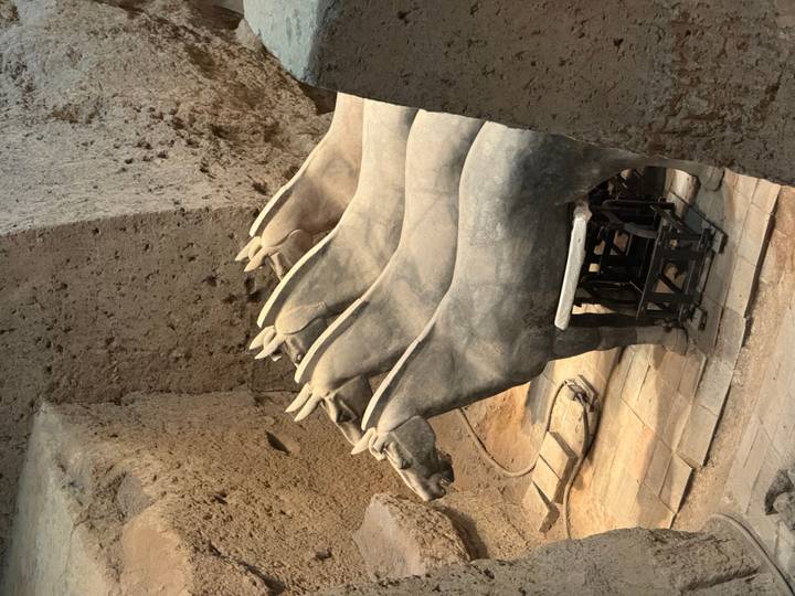 Stone terracotta war-horse statues in excavation pit at Xi'an's Terracotta Army site.