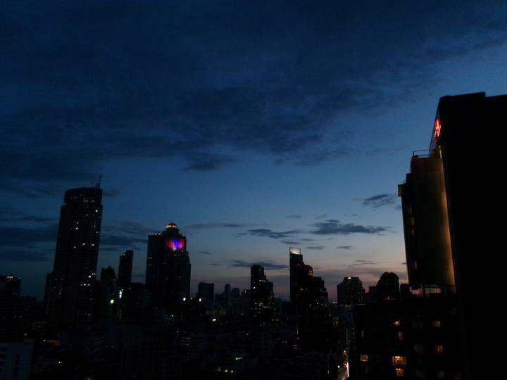 Bangkok city skyline at blue hour with deepening twilight and lit skyscrapers