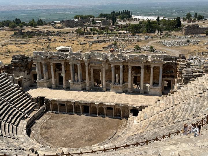 Well-preserved Roman theatre of Hierapolis viewed from above, surrounded by ruins.