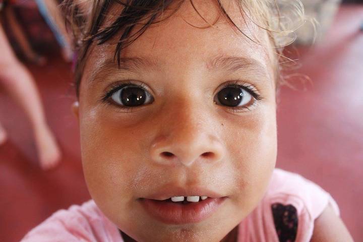 Close-up of a child's face indoors.