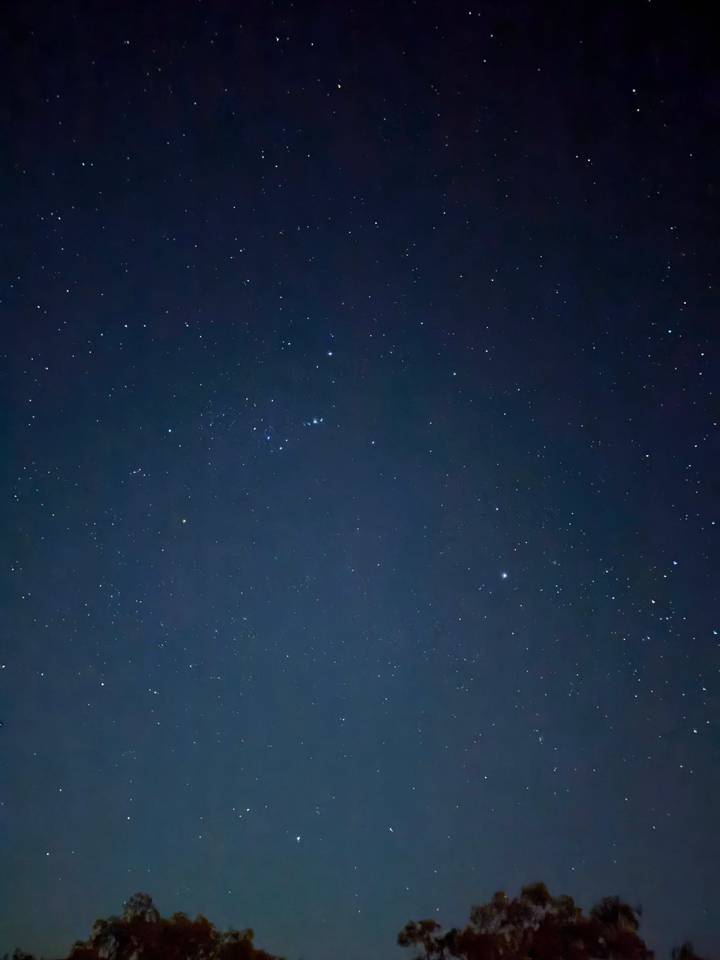 Clear night sky filled with countless stars against a deep blue backdrop.