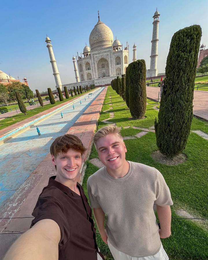 Two travellers take a selfie along the long pool leading to the Taj Mahal.