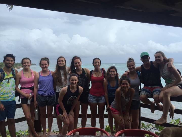 Group of friends posing by the shore.