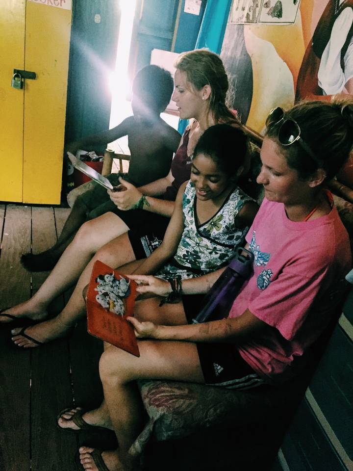 People reading and interacting in a relaxed setting.